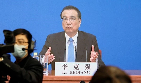 Chinese Premier Li Keqiang is seen on a screen as he attends a news conference in Beijing, China March 11, 2022. (REUTERS)