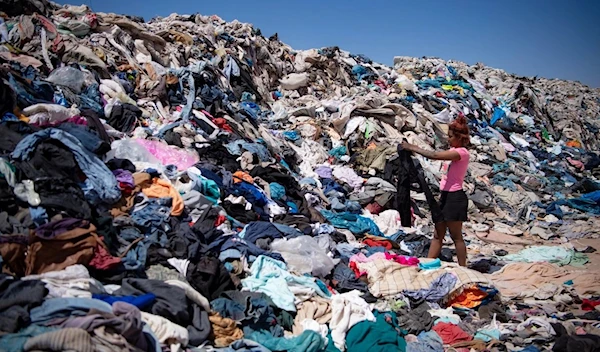 Women search for used clothes amid tons discarded in Chile's Atacama Desert (AFP)