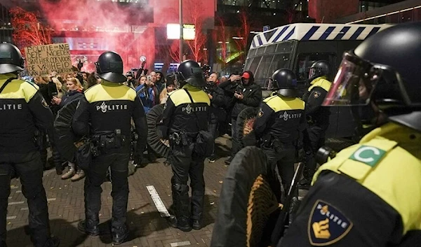 French riot police prevent an anti-Macron protest in central Paris