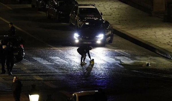 Police investigating site where two people were shot by police in Paris on April 25, 2022 (AFP)