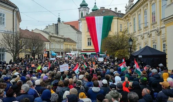 Supporters listen to Hungarian Prime Minister Viktor Orbán on Friday as he delivers a speech during the final electoral rally of his party ahead of Sunday's elections, Székesfehérvár, Hungary (AP)