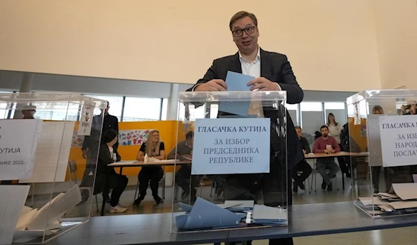 Serbian President Aleksandar Vucic casts his ballot at a polling station in Belgrade today.