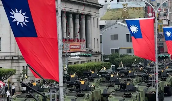 Armored vehicles that were not fitted with weapons, parade in front of Taiwan’s presidential palace. (Getty Images)