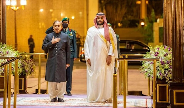 A handout picture provided by the Saudi Royal Palace shows Saudi Arabia's Crown Prince Mohammed bin Salman (R) welcoming Pakistani Prime Minister Shehbaz Sharif in Jeddah on April 30, 2022. (SPA)