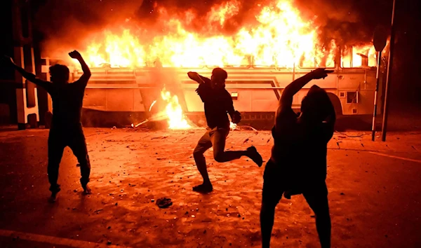 Protesters set a bus on fire during a demonstration outside the Sri Lankan president's home in Colombo on March 31. Protesters set a bus on fire during a demonstration outside the Sri Lankan president's home in Colombo on March 31. (AFP)