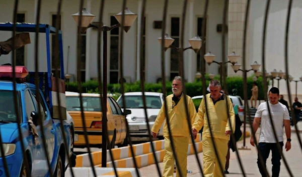 The two men look wearing a yellow outfit