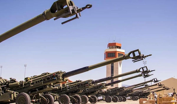 Marine Corps M777 155 mm howitzers are staged on the flight line prior to being loaded onto an Air Force C-17 Globemaster III aircraft at March Air Reserve Base, Calif, April 22, 2022 (US Marine Corps)