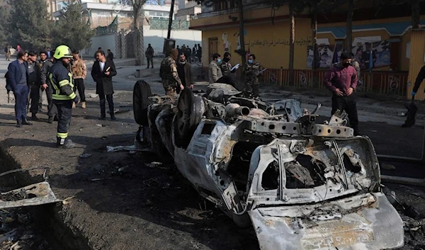 Afghan security officers inspect the site of a bombing attack in Kabul, Afghanistan, Sunday, Jan. 10, 2021. A roadside bomb exploded in Afghanistan's capital Sunday, killing at least a few people in a vehicle