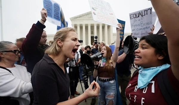 Pro-abortion and anti-abortion demonstrators protest outside the US Supreme Court after the leak of a draft majority opinion to overturn the landmark Roe v. Wade in Washington, US, May 3, 2022 (Reuters)