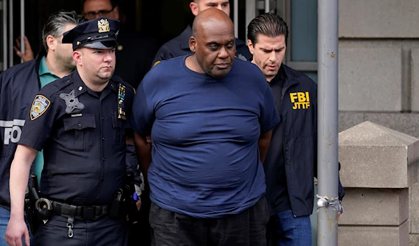 New York City Police and law enforcement officials lead subway shooting suspect Frank James away from a police station in New York, Wednesday, April 13, 2022 (AP)