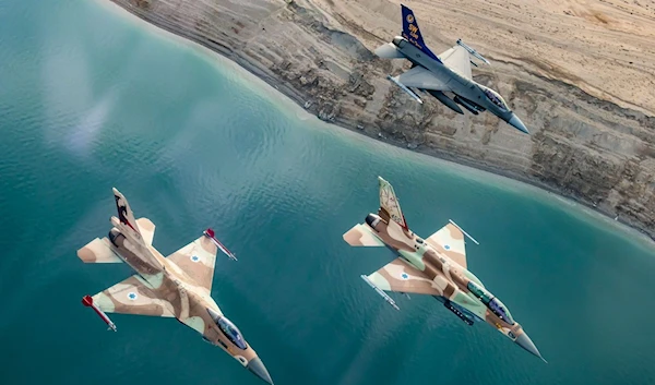 Two Israeli and one American F-16 fighter jets fly alongside one another during a joint exercise in southern occupied Palestine in January 2022