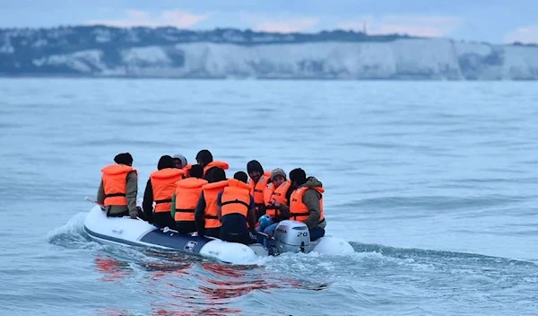 Migrants in a dinghy navigate in the English Channel (AFP)