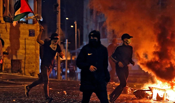 Palestinian protesters during confrontations with the Israeli occupation forces in occupied Al-Quds, occupied Palestine