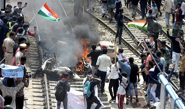 Indian police fire on crowd protesting army recruitment plan.