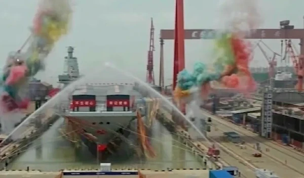 Water cannons spray China’s third aircraft carrier christened Fujian during its launching ceremony. (AP)