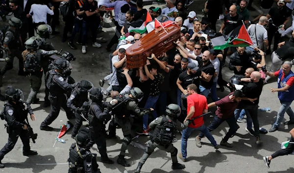 Israeli police charging at mourners carrying the casket of slain Palestinian journalist Shireen Abu Akleh in Al-Quds (AP)