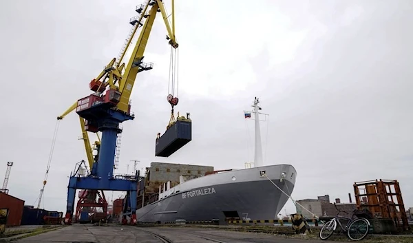 A crane lifts a shipping container at a commercial port in Kaliningrad, Russia, October 28, 2021 (Reuters)