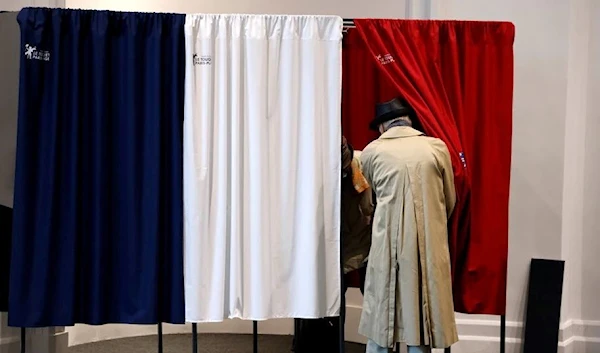 Voters enter a polling booth on June 27, 2021. (REUTERS)