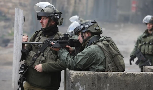 Israeli occupation forces on Palestinian land during confrontations with Palestinians