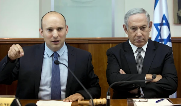 Then-Israeli Prime Minister Benjamin Netanyahu with then-Education Minister Naftali Bennett during a weekly cabinet meeting in occupied Al-Quds, August 30, 2016 (AP)