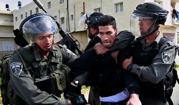 Israeli occupation soldiers detaining a Palestinian man in the West Bank, occupied Palestine