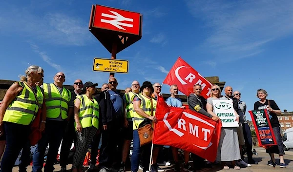 Rail workers strike outside Preston Station, on the first day of national rail strike in Preston, Britain, June 21, 2022. (Reuters)