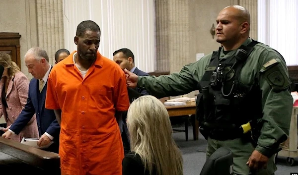 Singer R. Kelly walks away after appearing for a hearing at the Leighton Criminal Courthouse in Chicago on September 17, 2019. (AP)