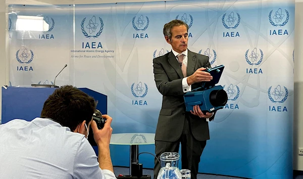 IAEA  Director-General Rafael Grossi presents a surveillance camera at the agency's headquarters , December 17, 2021 (Reuters)