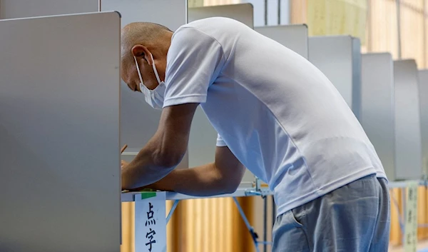 A voter prepares to cast his ballot in the upper house election at a polling station in Tokyo, Japan July 10, 2022. (Agencies)