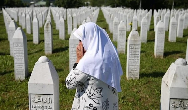 A woman prays at a graveyard, ahead of a mass funeral in Potocari near Srebrenica, Bosnia and Herzegovina July 11, 2020. (Reuters)