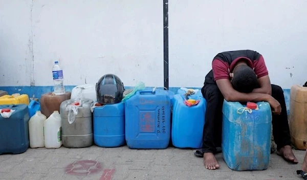 A man rests while waiting in a line to buy diesel near a fuel station in Colombo, Sri Lanka. (Reuters)