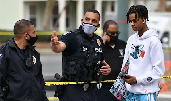 Police officers cordon the area after U.S. Marshalls shot and killed a man who was a suspect at a gas station in Charlotte, N.C., March 23, 2021. (Anadolu Agency)