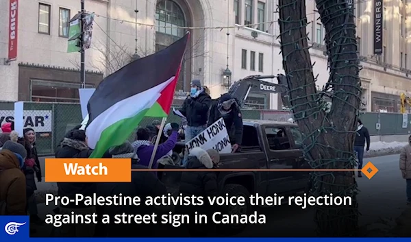 Pro-Palestine activists voice their rejection against a street sign in Canada