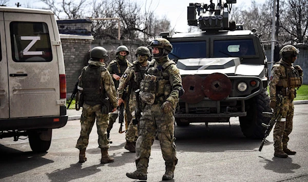 Russian soldiers patrol a street on April 11, 2022, in Volnovakha in the Donetsk People's Republic (AFP)