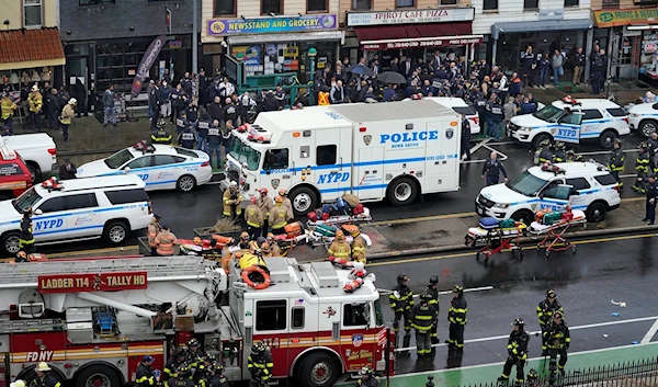 Emergency personnel gather at the entrance to a subway stop in the Brooklyn borough of New York following a mass shooting on April 12, 2022 (AP)