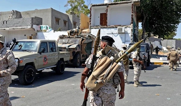 Members of the "444 Brigade" affiliated with Libya's Ministry of Defense man in Tripoli's suburb of Ain Zara. (AFP)