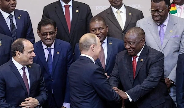 Russian President Vladimir Putin shakes hands with South African President Cyril Ramaphosa at the 2019 Russia-Africa summit. (AFP)