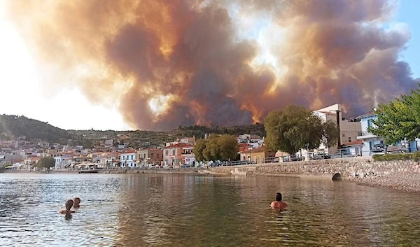 Flames burn on the mountain near Limni village on the island of Evia, about 160 kilometres (100 miles) north of Athens, Greece, Tuesday, August 3, 2021. (AP)