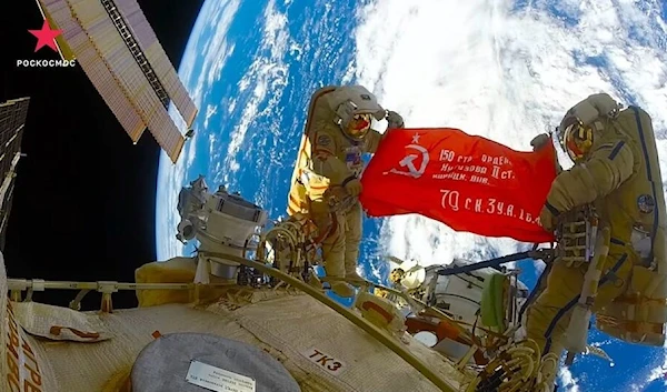 Cosmonauts unfurled a Soviet-era victory banner on a recent space walk