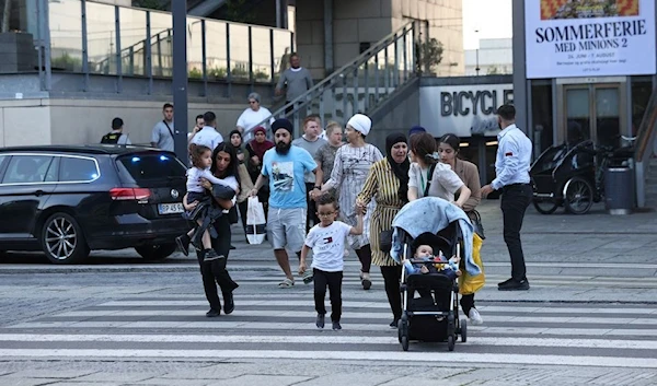 People leave Field's shopping center, after Danish police said they received reports of shooting, in Copenhagen, Denmark, July 3, 2022 (Reuters)