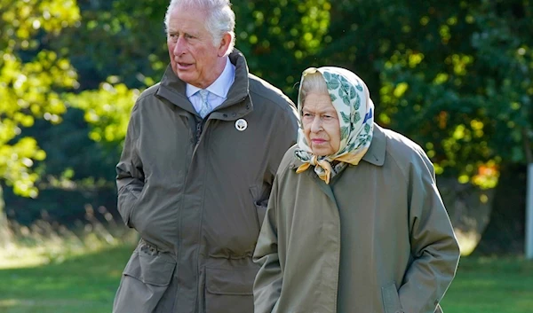 Queen Elizabeth II with her son and heir, Prince Charles, in Balmoral, Scotland, in October 2021 (AP)