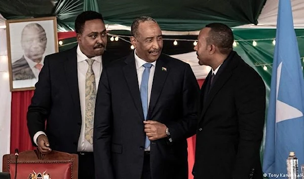 Al-Burhan (center) met with Ahmed (right) at a regional conference