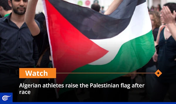 Algerian athletes raise the Palestinian flag after race