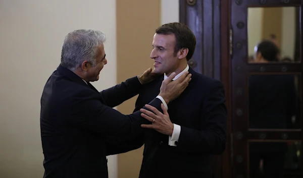 French President Emmanuel Macron, right, meets with Yair Lapid, left, in occupied Al-Quds on Jan. 22, 2020