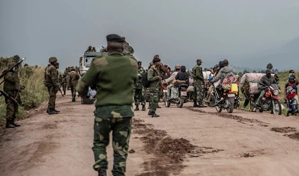 FILE - People walk on the road near Kibumba, north of Goma, Democratic Republic of Congo, as they flee fighting between Congolese forces and M23 rebels in North Kivu (Archive