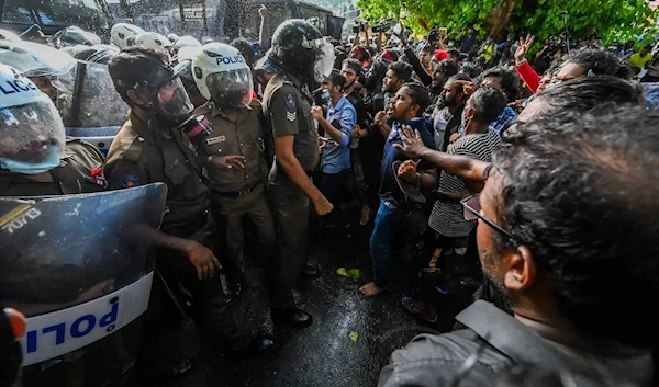 University students speak with police during a demonstration demanding the resignation of Sri Lankan President Gotabaya Rajapaksa in Colombo, Sri Lanka, on May 19, 2022 (Getty)