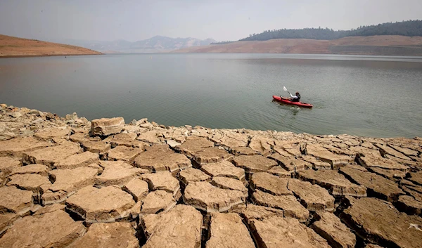 A kayaker fishes in Lake Oroville as water levels remained low due to continuing drought conditions in California on Aug. 22, 2021