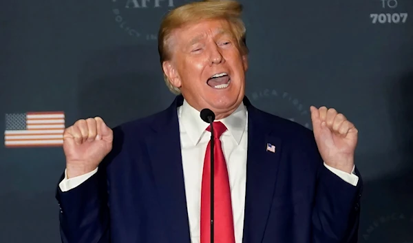 Former President Donald Trump talks about lifting weights as he speaks at an America First Policy Institute agenda summit at the Marriott Marquis in Washington, United States, July 26, 2022