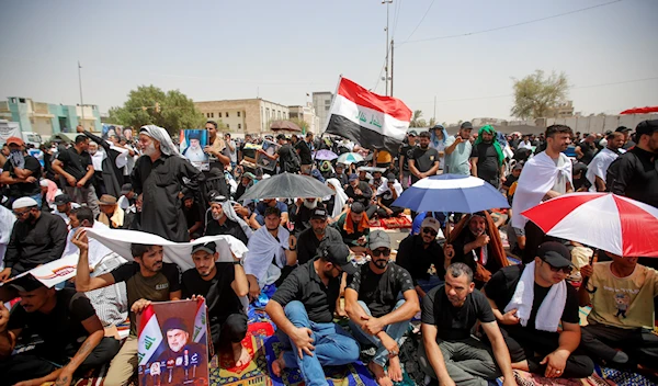 Supporters of Muqtada al-Sadr hold prayer near the parliament building in Baghdad, Iraq, Friday, Aug. 12, 2022 (AP Photo/Anmar Khalil)