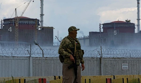 A serviceman with a Russian flag on his uniform stands guard near the Zaporozhye NPP. (Archive)